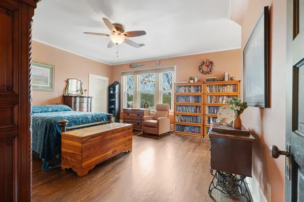 a living room with furniture and a book shelf