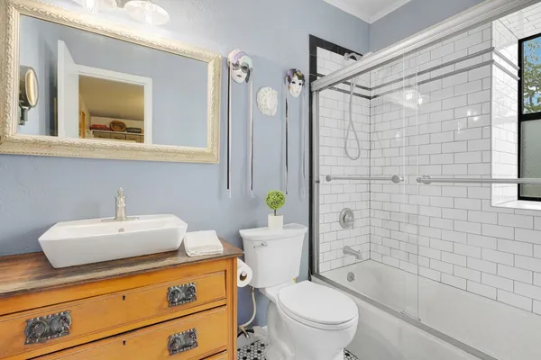 a bathroom with a sink a toilet and shower