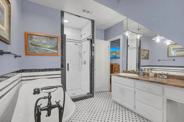 a bathroom with a sink a mirror and a shower