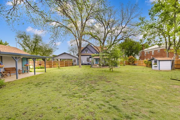 a view of a yard with a house in the background