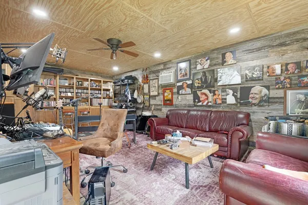 a living room with lots of furniture and kitchen view