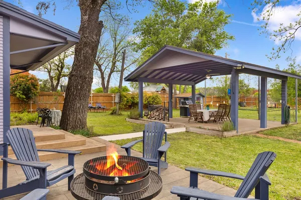a view of a patio with a table chairs and a backyard