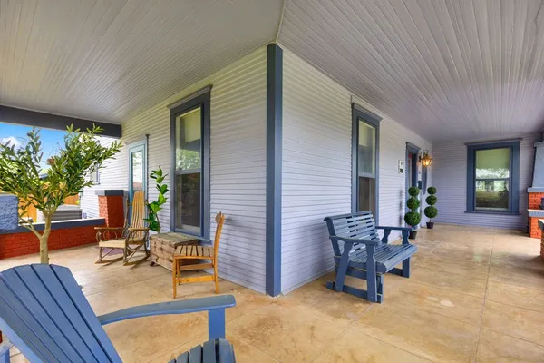 a view of a livingroom with furniture and floor to ceiling window