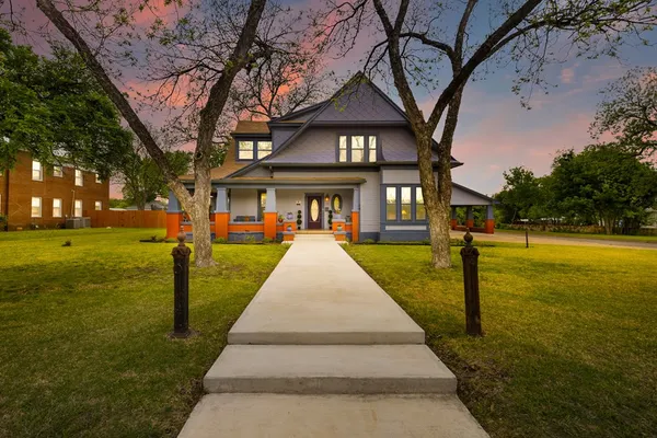 a front view of a building with palm trees