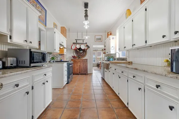 a kitchen with cabinets and window