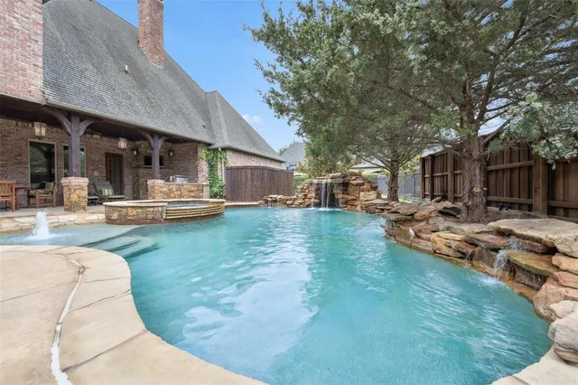 a view of a patio with swimming pool table and chairs