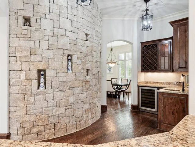 a view of a entryway with kitchen and hall with wooden floor