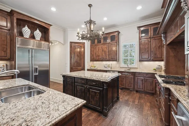 a kitchen with stainless steel appliances granite countertop a sink stove and refrigerator