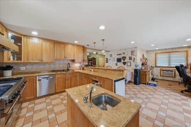 a kitchen with stainless steel appliances granite countertop a sink stove and refrigerator