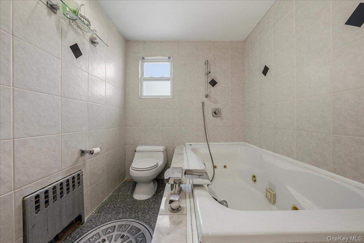 47-23 164th Street Queens, NY 11358 - Photo 19 of 47 a bathroom with a bathtub and a toilet