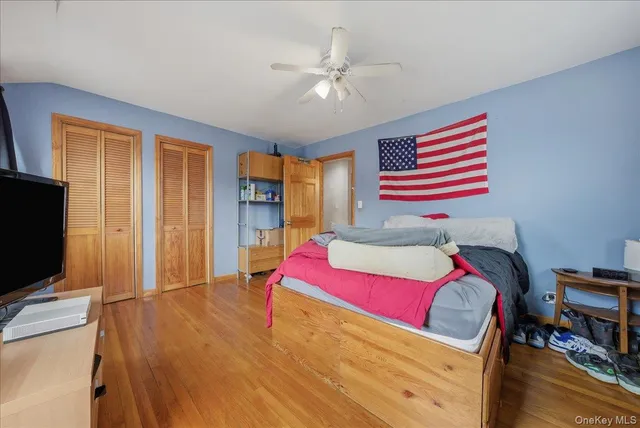 a bedroom with a bed and a television