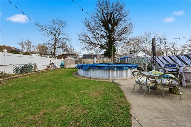 a view of a house with garden and a bench