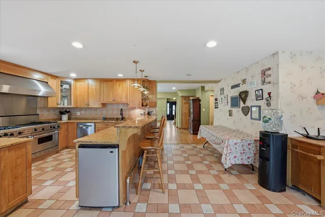 a kitchen with stainless steel appliances granite countertop a stove top oven a sink a counter top space and cabinets