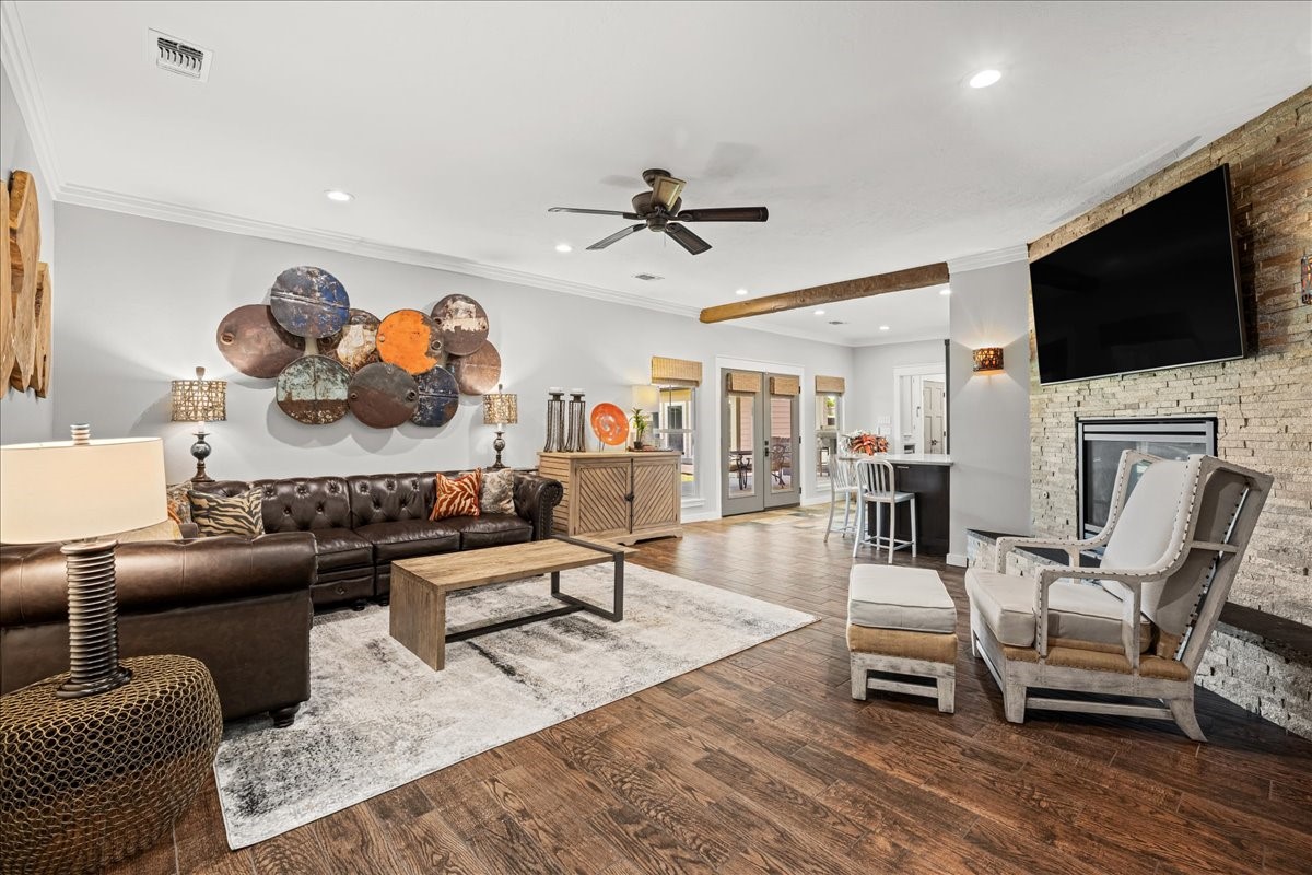 1502 Reimer Street Brenham, TX 77833 - Photo 9 of 30 a living room with furniture a flat screen tv and kitchen view