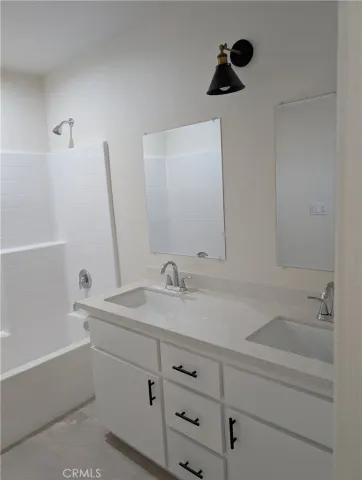 a bathroom with a shower and a sink