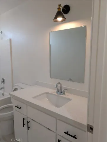 a room with cabinet and mirrors