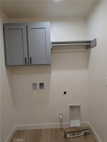 a view of storage and utility room with wooden floor