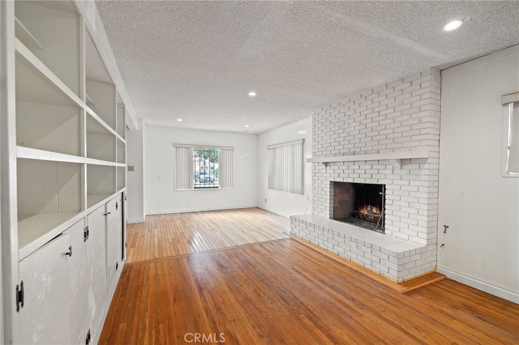 4761 West 141st Street Hawthorne, CA 90250 - Photo 1 of 29 a view of a livingroom with wooden floor and a fireplace