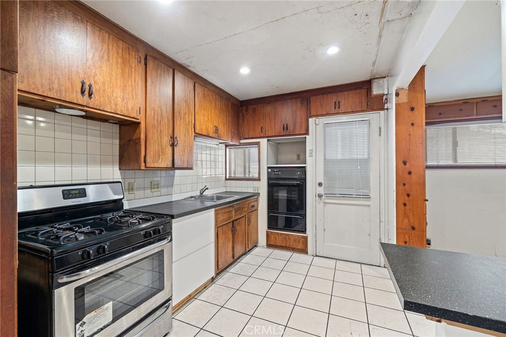 4761 West 141st Street Hawthorne, CA 90250 - Photo 4 of 29 a kitchen with stainless steel appliances granite countertop a stove a refrigerator and a cabinets