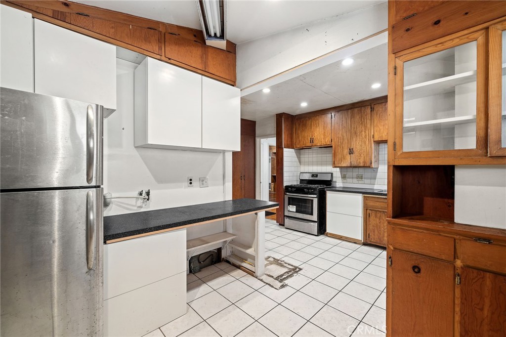 4761 West 141st Street Hawthorne, CA 90250 - Photo 5 of 29 a kitchen with stainless steel appliances a refrigerator sink and cabinets