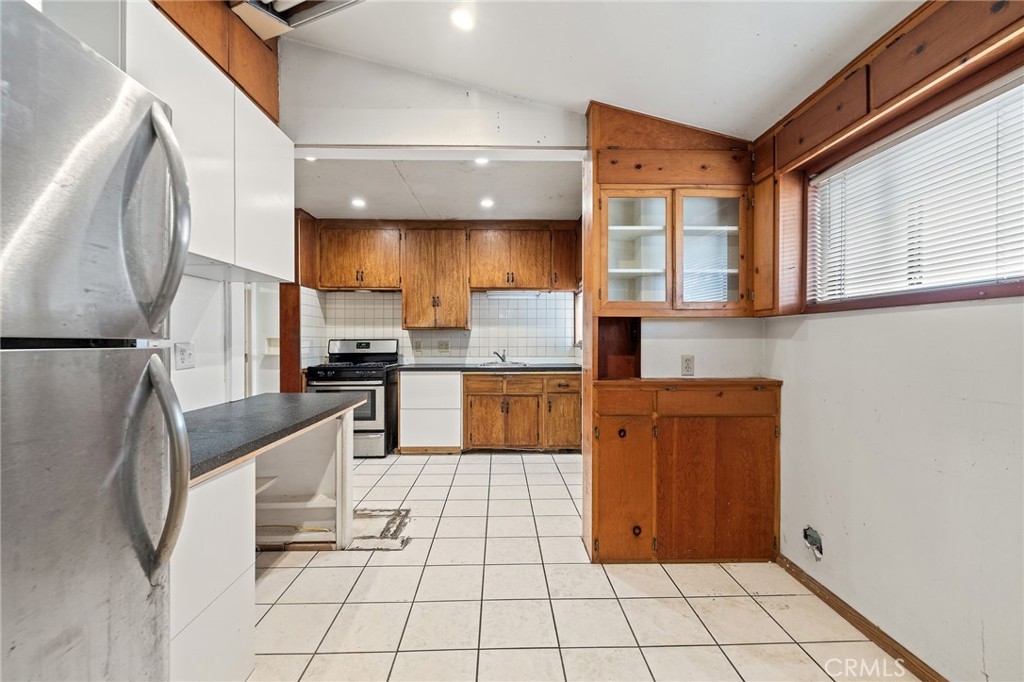 4761 West 141st Street Hawthorne, CA 90250 - Photo 6 of 29 a kitchen with stainless steel appliances granite countertop a refrigerator and a stove top oven