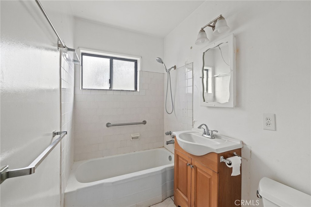 4761 West 141st Street Hawthorne, CA 90250 - Photo 10 of 29 a bathroom with a tub sink and mirror