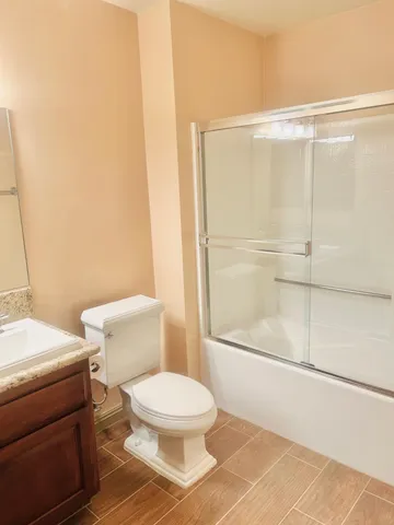 a white toilet sitting next to a bathroom sink