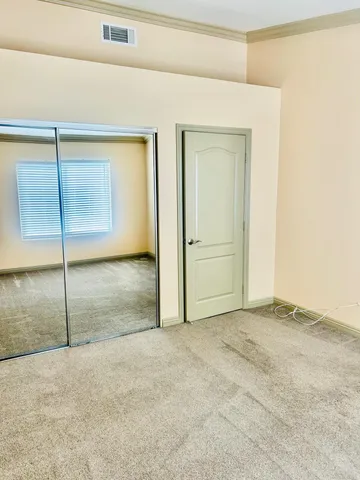 an empty room with a ceiling fan