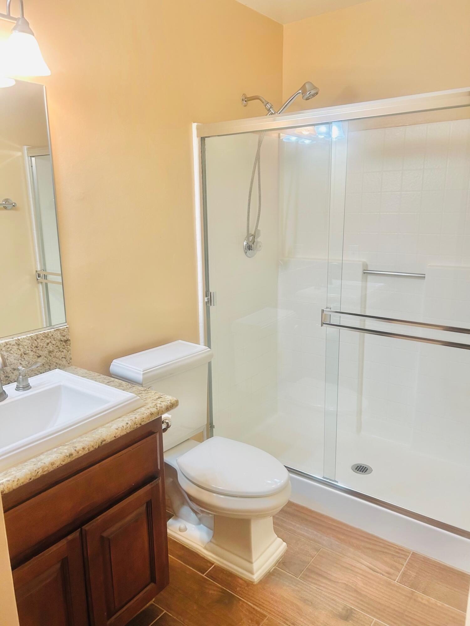 40780 Breezy Pass Road, Unit B Palm Desert, CA 92211 - Photo 23 of 32 a bathroom with a sink a toilet and shower