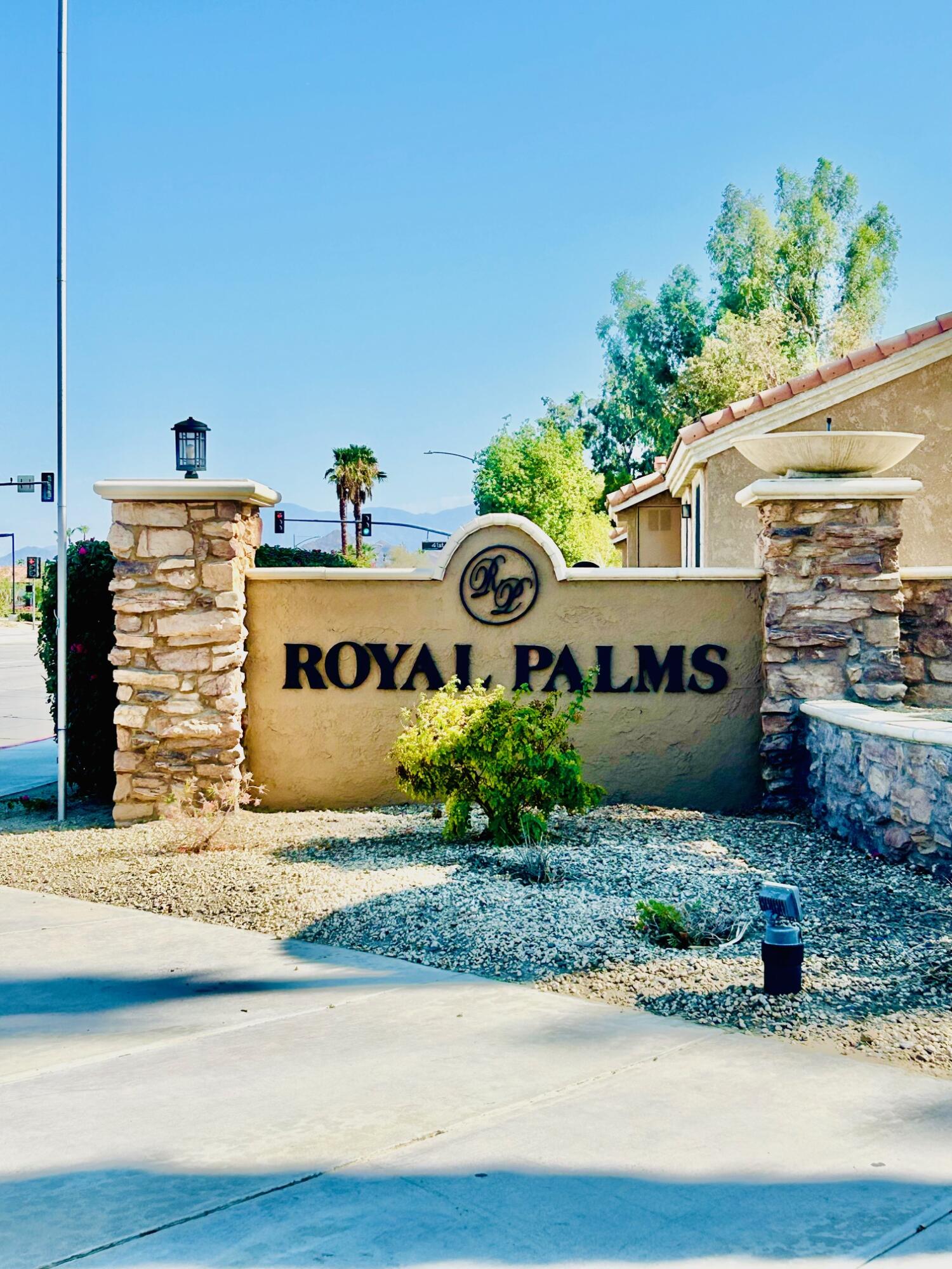 40780 Breezy Pass Road, Unit B Palm Desert, CA 92211 - Photo 32 of 32 a front view of a house with a yard and garage