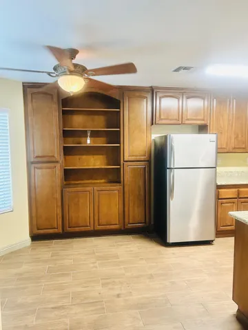 a kitchen with a refrigerator and a refrigerator