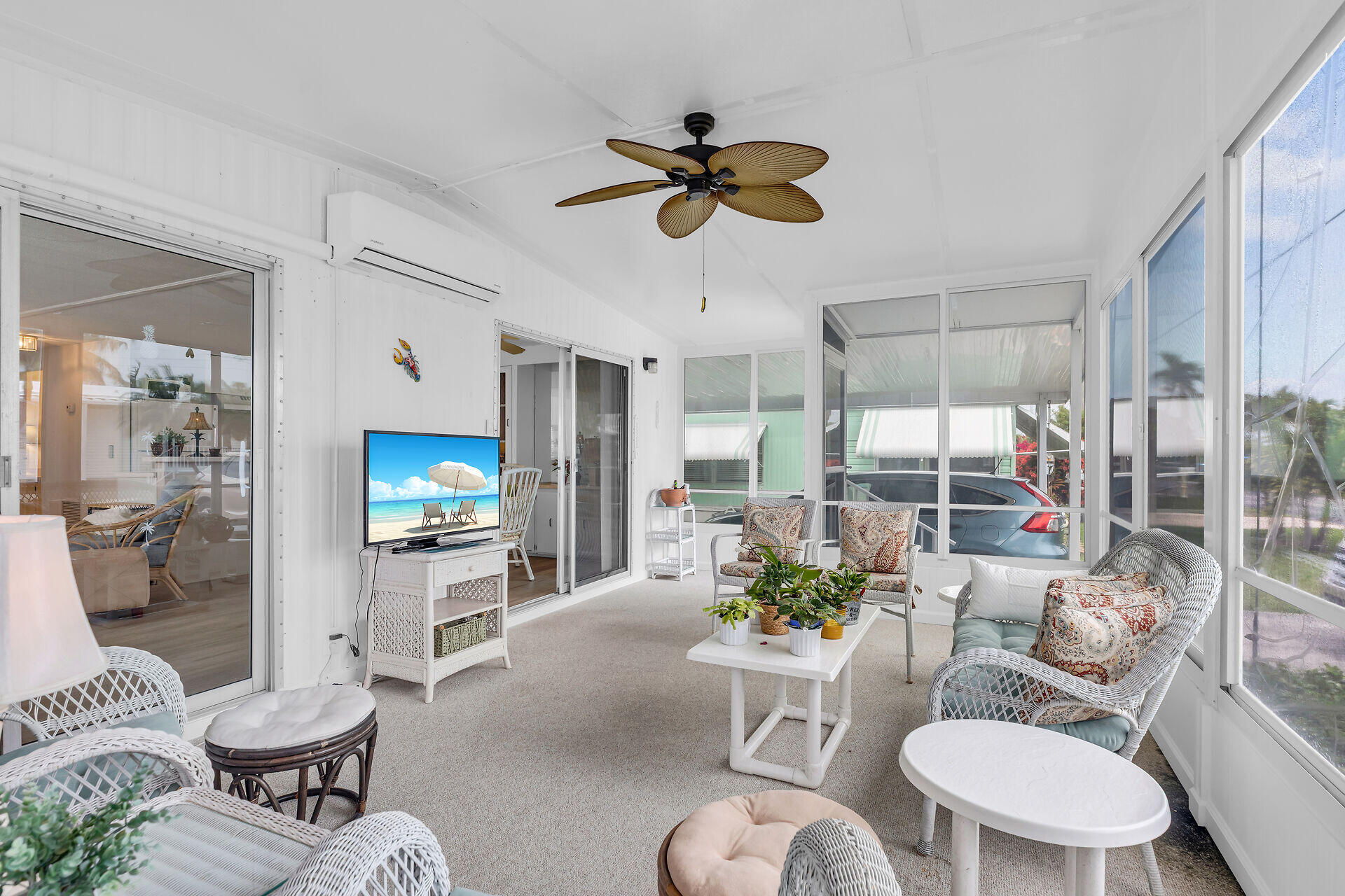 812 South Silver Circle Key Largo, FL 33037 - Photo 11 of 41 a living room with furniture a chandelier a window and a flat screen tv