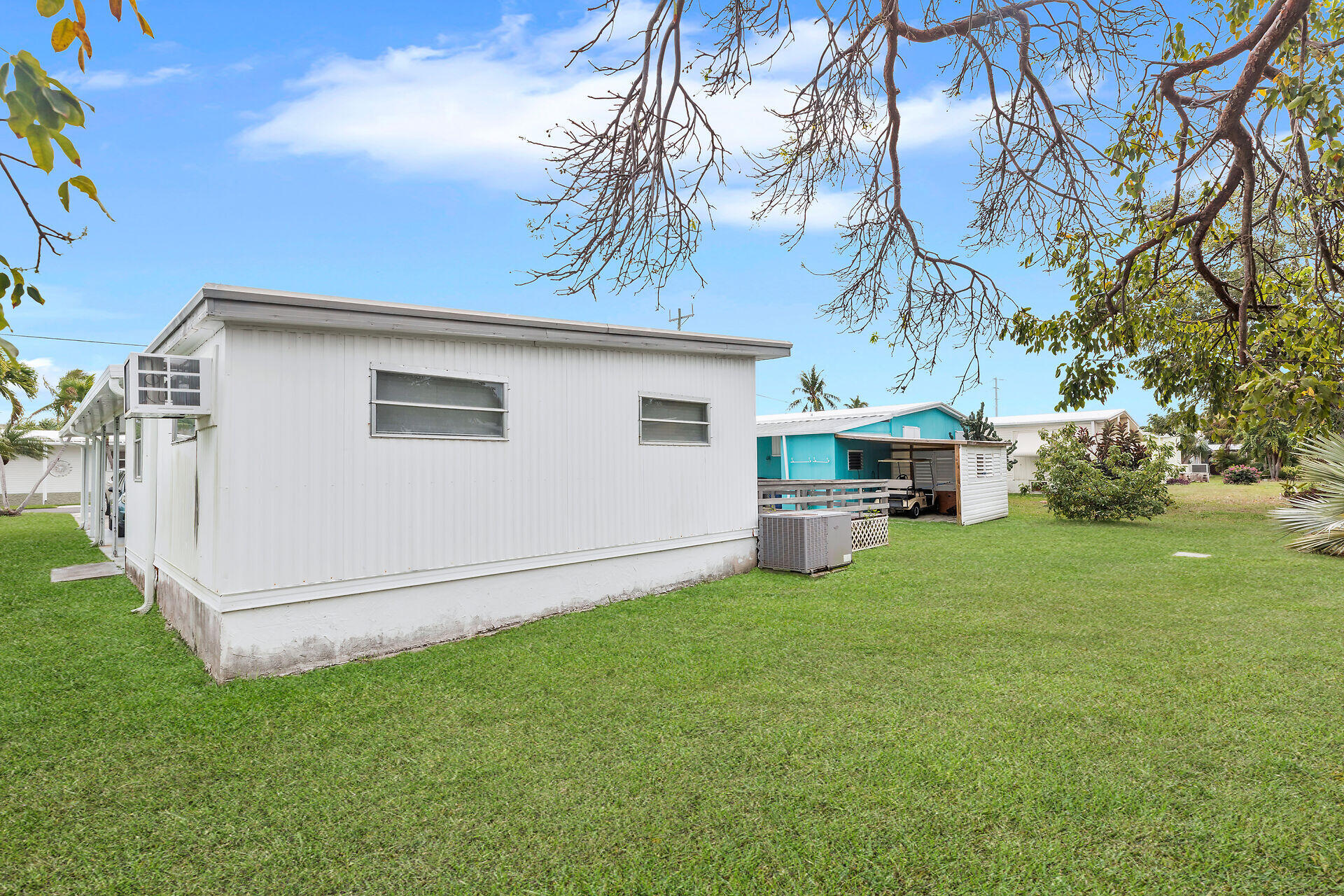 812 South Silver Circle Key Largo, FL 33037 - Photo 27 of 41 a view of a white house that has a small yard and large trees