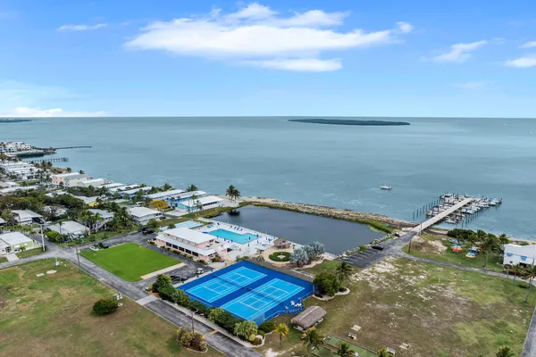 an aerial view of a house with a swimming pool an outdoor seating