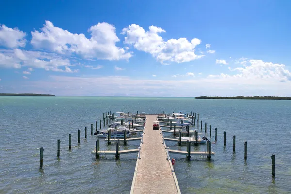 a view of a swimming pool with outdoor seating and a lake view