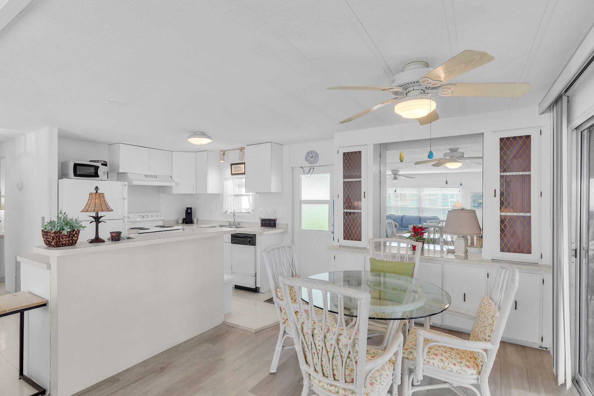 812 South Silver Circle Key Largo, FL 33037 - Photo 5 of 41 a kitchen with white cabinets and chairs