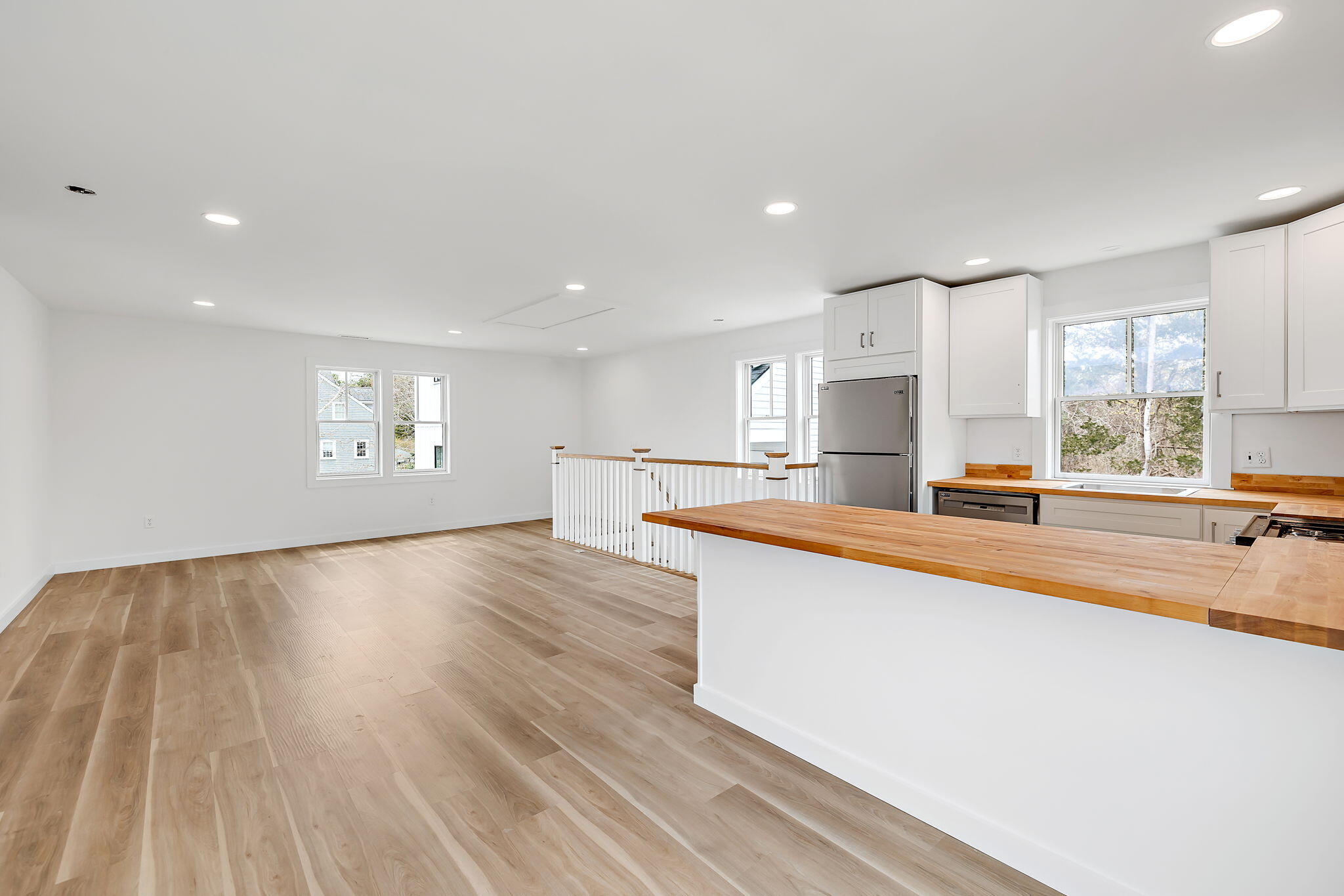 66 Doane Road Harwich Port, MA 02646 - Photo 24 of 40 a large white kitchen with wooden floors and view living room