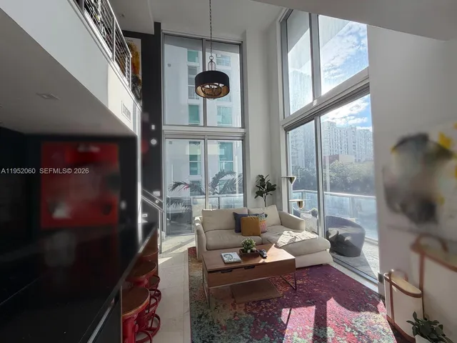 a living room with furniture and a large window