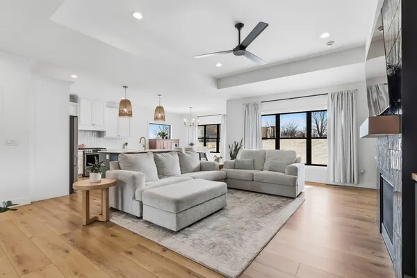 a living room with furniture and a wooden floor