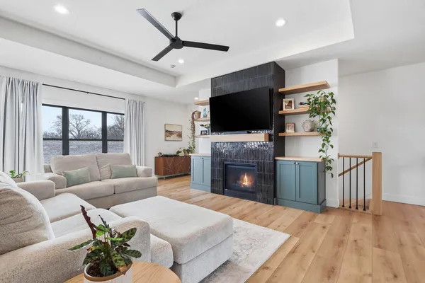 a living room with furniture a fireplace and a flat screen tv