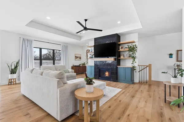 a living room with furniture a fireplace and a flat screen tv