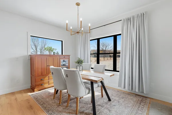 a view of a dining room with furniture window and wooden floor