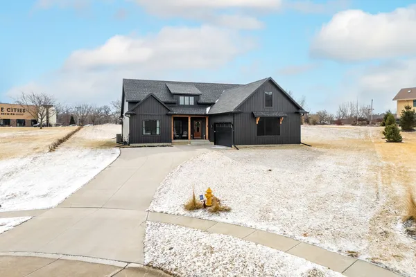 a view of a house with a yard covered in snow