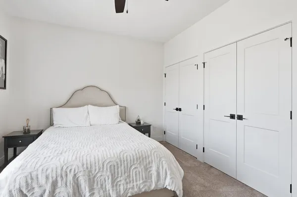 a bedroom with a bed and a painting on the wall