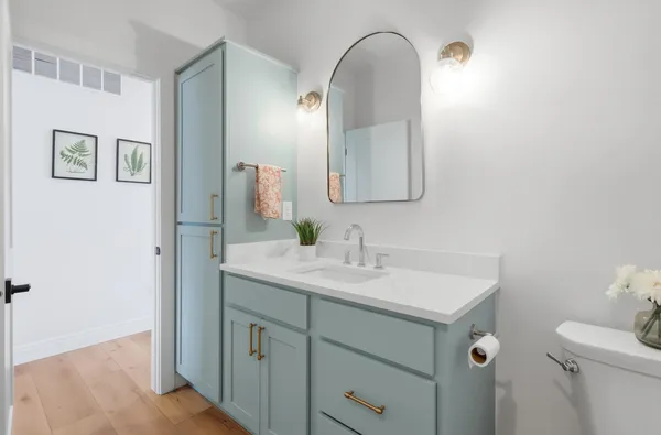 a bathroom with a toilet sink and mirror
