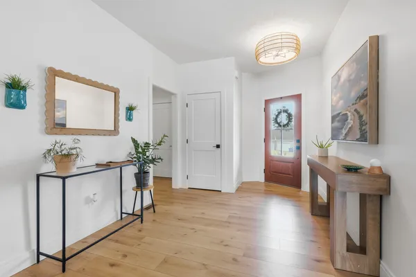 a view of an entryway with wooden floor