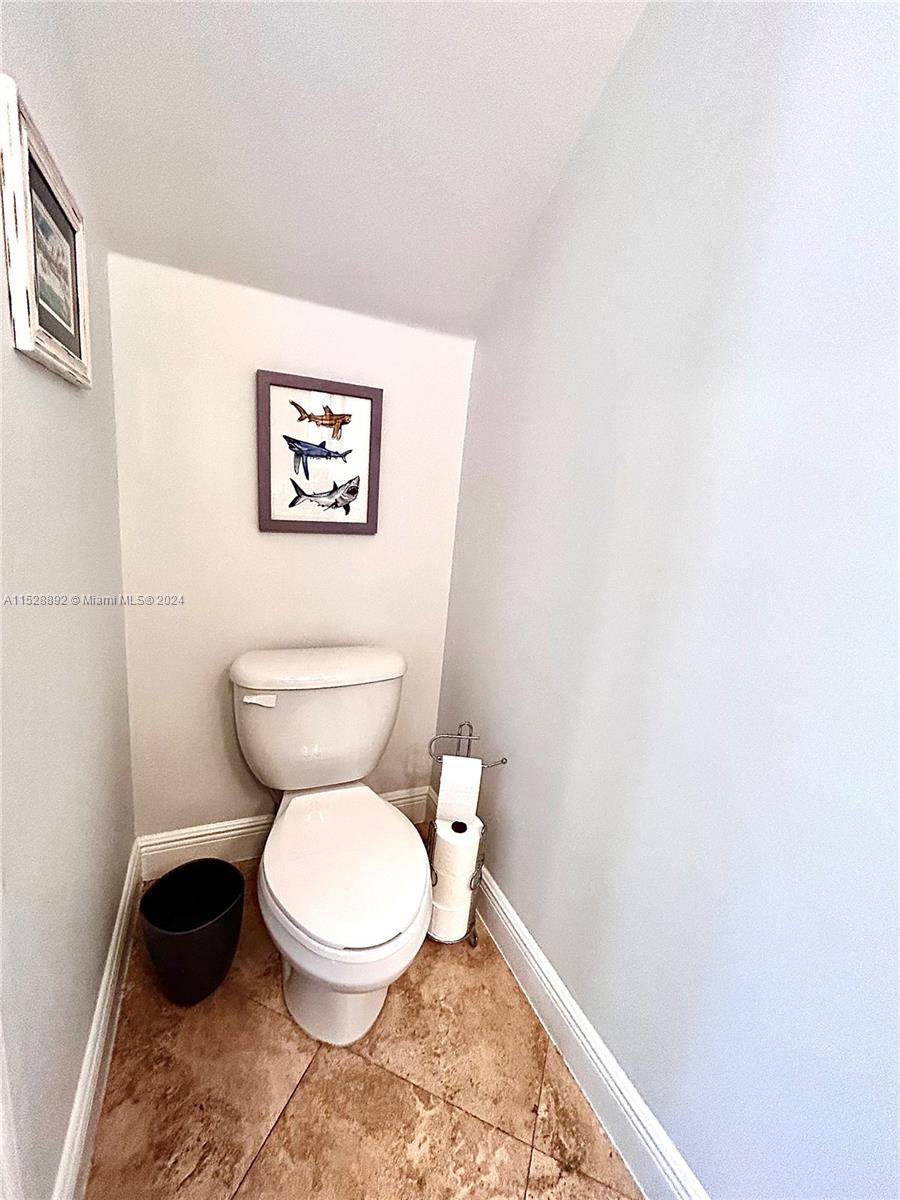 a white toilet sitting next to a small bathroom