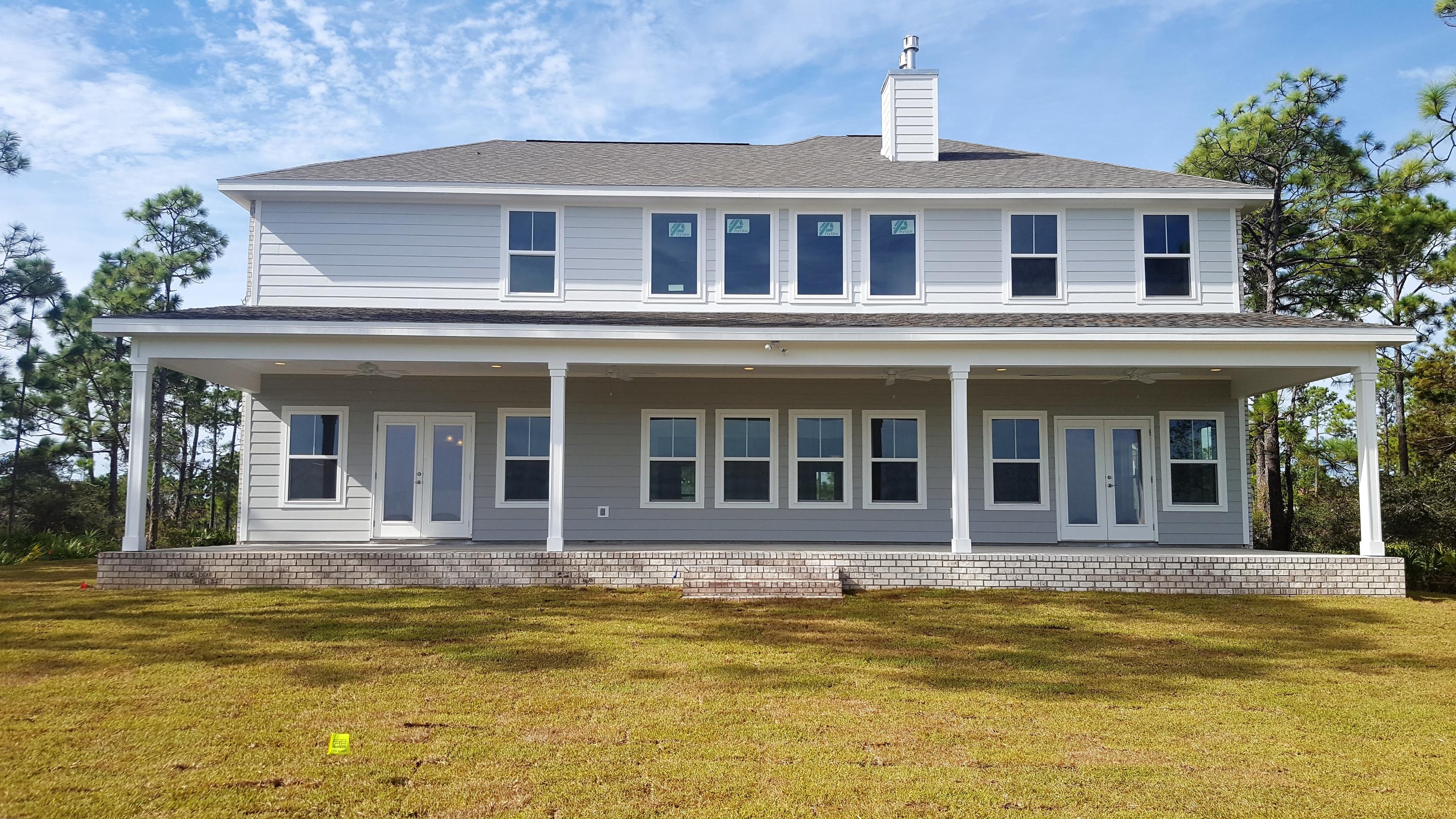 1477 Driftwood Point Road Santa Rosa Beach, FL 32459 - Photo 13 of 15 a view of a white house with a swimming pool
