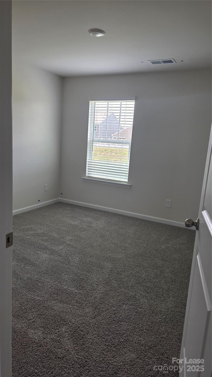 1345 Secrest Cmns Drive Monroe, NC 28112 - Photo 11 of 19 an empty room with a empty space and windows