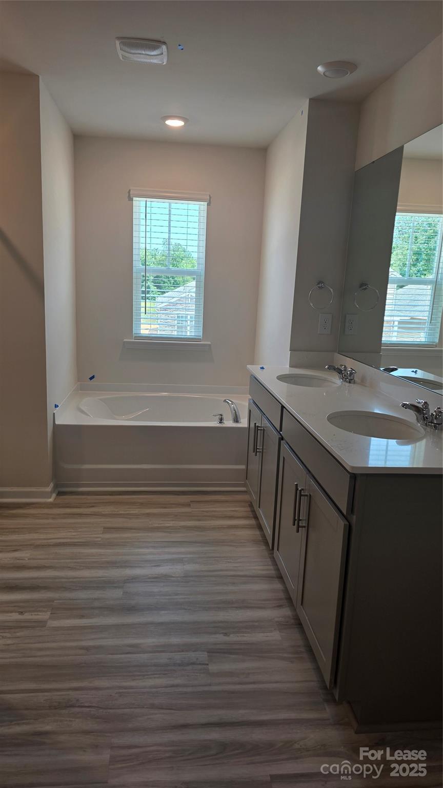 1345 Secrest Cmns Drive Monroe, NC 28112 - Photo 14 of 19 a view of a kitchen with kitchen island a sink wooden floor and a window